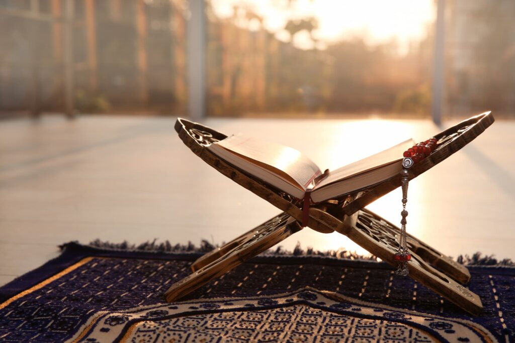 Book and prayer beads on a prayer rug