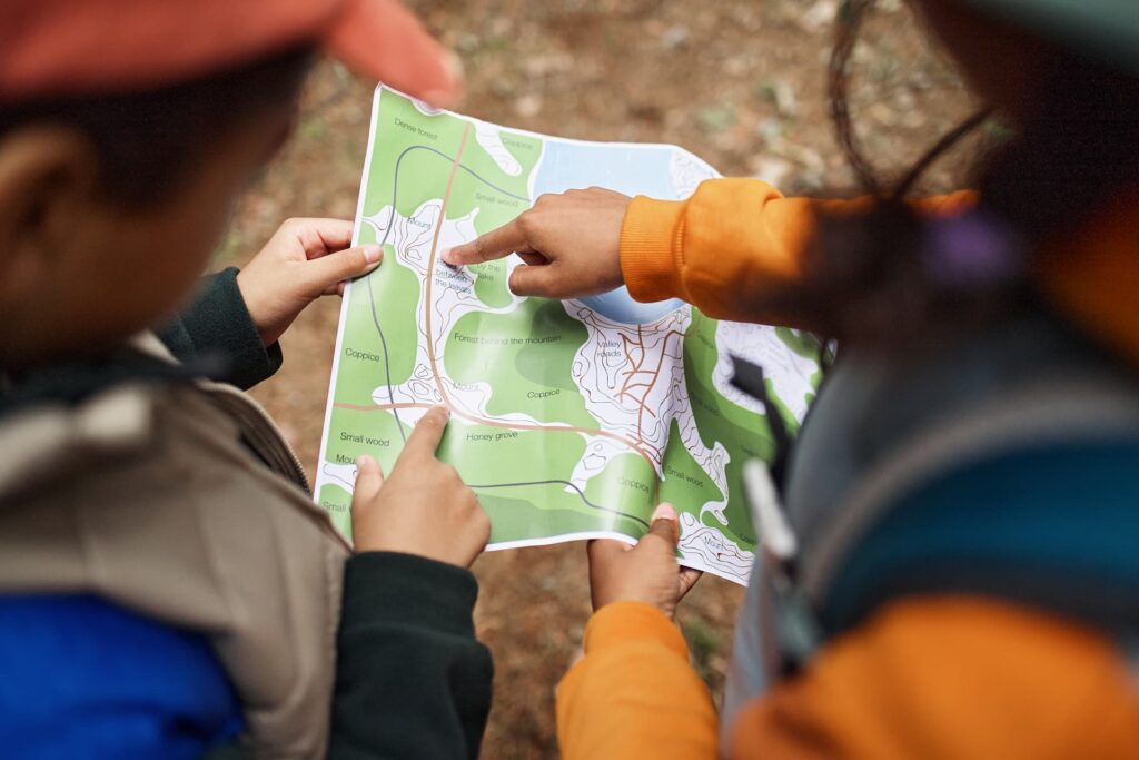 Children using a map during a hike