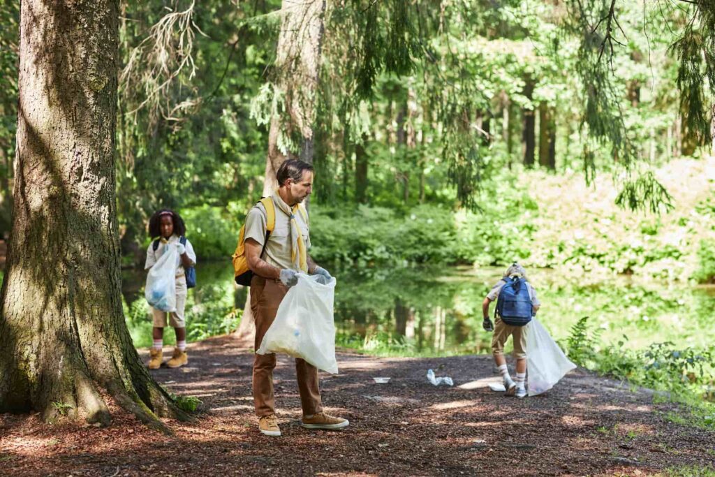 Forest cleanup with volunteers collecting garbage