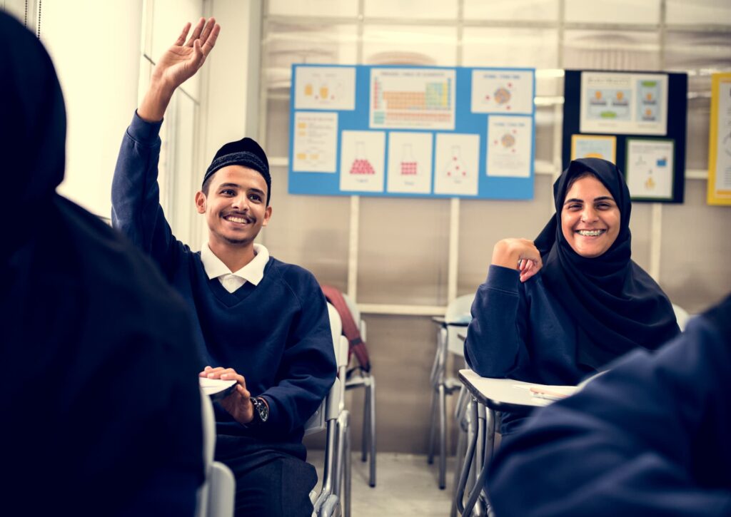 Smiling students learning together in classroom